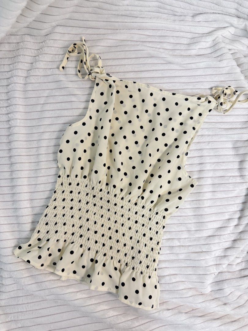 Polka Dot Smocked Cami Top (Category: Sleeveless) located in Rizal. Submitted by kianapreloves (Listing ID 1468591528, Image 1). Description: - Color & Pattern: Cream with black polka dots - Size: XS - Material: 100% polyester - Design: Adjustable tie shoulders, stretchy smocked body, and ruffled hem - Care: Machine washable .