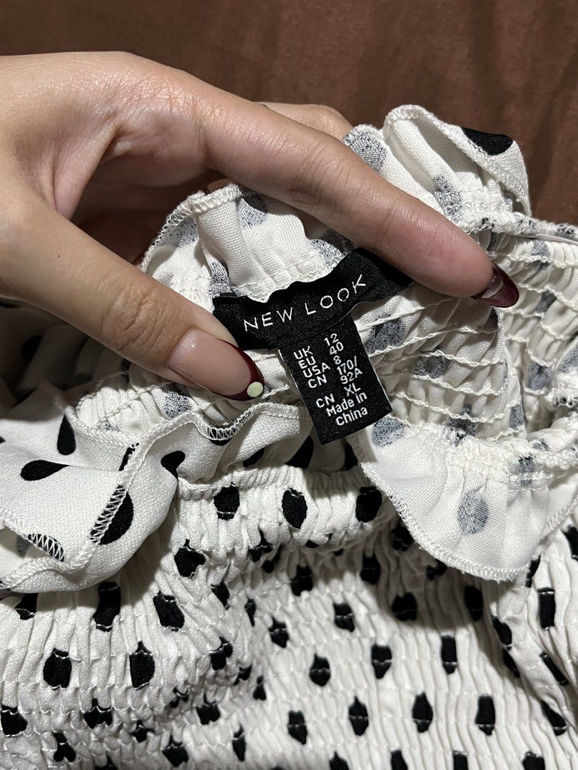 Polka Self Tie Smocked Top Size S (Category: Blouses) located in Manila. Submitted by maaya.rikit (Listing ID 1468621317, Image 3). Description: - Color/Pattern: White with all-over black polka dots - Size: S - Fit/Details: Smocked elastic body with ruffled trim at the top and bottom - Straps: Self-tie ribbon shoulder straps - Versatility: Great basic for sunny days or layering under jackets.