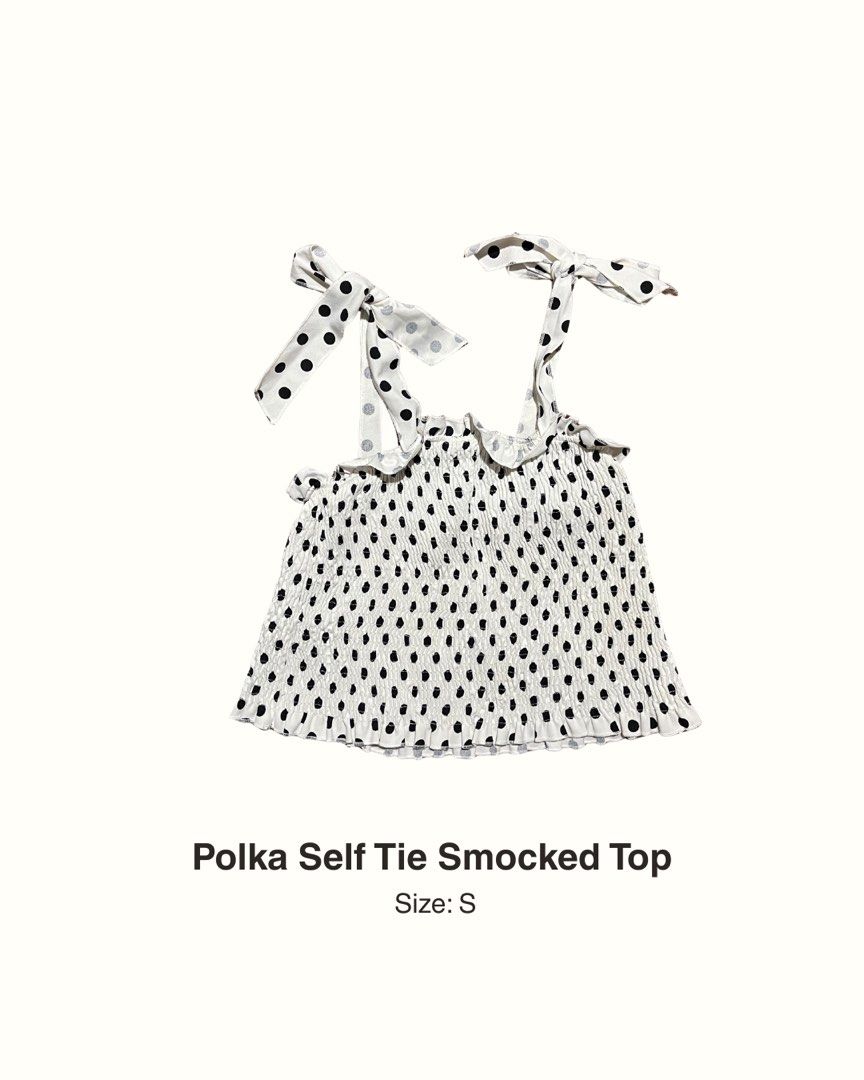 Polka Self Tie Smocked Top Size S (Category: Blouses) located in Manila. Submitted by maaya.rikit (Listing ID 1468621317, Image 1). Description: - Color/Pattern: White with all-over black polka dots - Size: S - Fit/Details: Smocked elastic body with ruffled trim at the top and bottom - Straps: Self-tie ribbon shoulder straps - Versatility: Great basic for sunny days or layering under jackets.