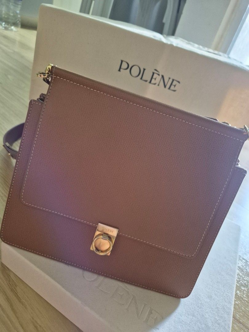 Polène structured leather shoulder bag in tan with box (Category: Luxury Bags & Wallets) located in Makati City. Submitted by beautiful_jj (Listing ID 1468562703, Image 2). Description: - Brand: Polene - Color: Rich Tan - Material: Premium leather with luxurious suede lining - Design: Structured square flap with secure gold-tone hardware clasp and engraved logo - Strap: Adjustable shoulder strap featuring a gold metal keeper - Interior: Organized
