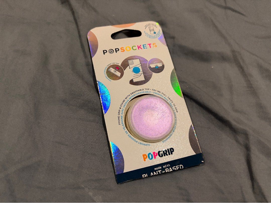 PopSockets PopGrip Plant-Based Purple Iridescent (Category: Cases & Sleeves) located in Marikina City. Submitted by nj1989 (Listing ID 1468569792, Image 1). Description: Flaws: Few scratches on pop top - Made from eco-friendly plant-based material - Beautiful purple iridescent finish with a subtle color shift - Swappable top design so you can change up your style anytime - Versatile design functions as both a secure phone grip and a convenient st