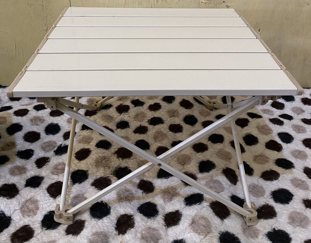 Portable Foldable Camping Table Aluminium Slat Top (Category: Hiking & Camping) located in Baguio. Submitted by thrift_bonita (Listing ID 1468553115, Image 1). Description: - Compact folding table with roll-up slat top and X-frame metal legs - Lightweight, easy to set up, and packs down small - Ideal for camping trips, picnics, or outdoor markets - Neutral beige and white color scheme matches most outdoor gear - Sturdy and durable construction.
