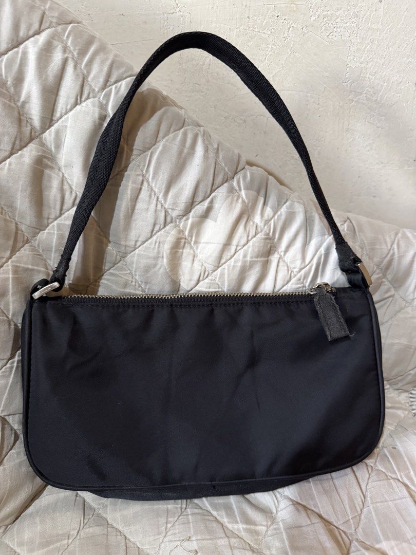 Prada Black Nylon pochette small (Category: Luxury Bags & Wallets) located in Danao, Cebu. Submitted by jojie.1983 (Listing ID 1468578730, Image 3). Description: - Brand: Prada thrift source expect normal sign of use - Small size - Style: Nylon Material pochette - not lampo zipper no white tag - Color: Classic Black with Silver-Tone Hardware - Features: Iconic metal triangle logo, zip top closure, and comfortable shoulder strap with metal buckles