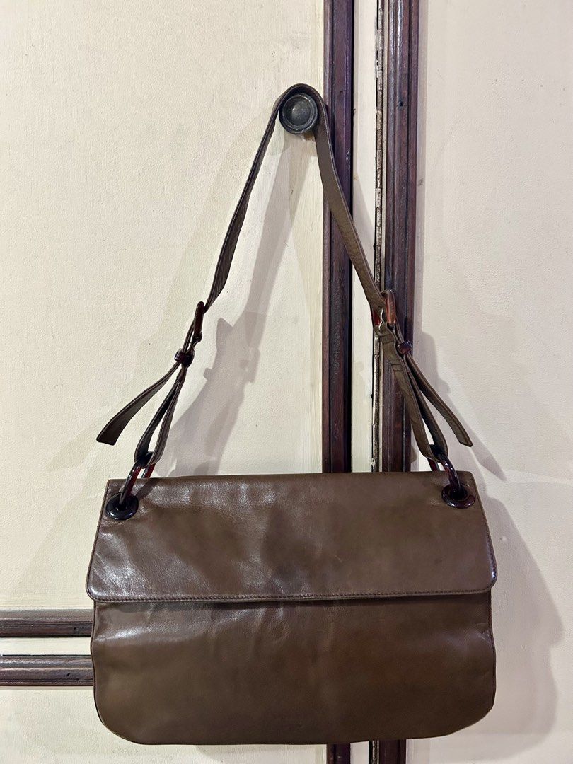 Prada Tessuto Vitello Shoulder Bag (Category: Luxury Bags & Wallets) located in Manila. Submitted by rosamanerds (Listing ID 1468552900, Image 2). Description: - Authentic pre-loved vintage Prada Tessuto Leather and nylon shoulder bag - Closure: magnetic flap - Straps: Adjustable with stylish tortoiseshell rings - Shape: Structured rectangular with gussets - Details: Embossed Prada logo near the bottom front corner - Condition: excellent. Clean b