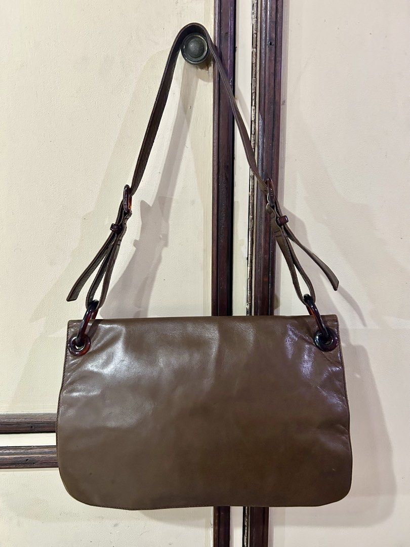 Prada Tessuto Vitello Shoulder Bag (Category: Luxury Bags & Wallets) located in Manila. Submitted by rosamanerds (Listing ID 1468552900, Image 3). Description: - Authentic pre-loved vintage Prada Tessuto Leather and nylon shoulder bag - Closure: magnetic flap - Straps: Adjustable with stylish tortoiseshell rings - Shape: Structured rectangular with gussets - Details: Embossed Prada logo near the bottom front corner - Condition: excellent. Clean b