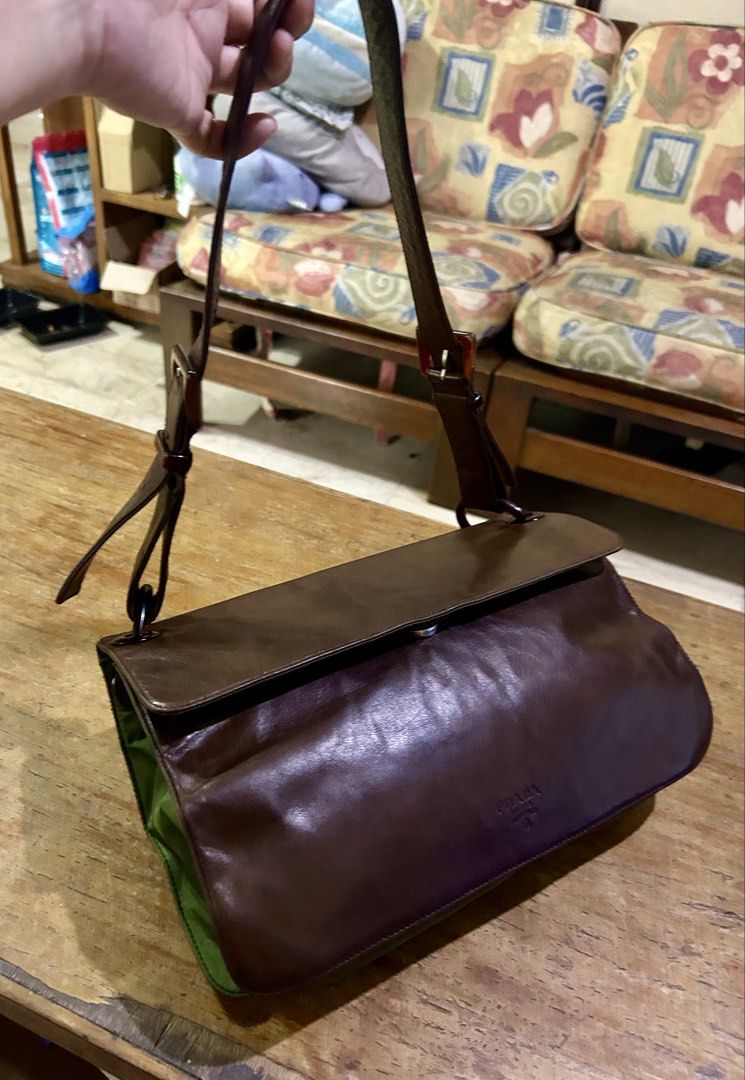Prada Tessuto Vitello Shoulder Bag (Category: Luxury Bags & Wallets) located in Manila. Submitted by rosamanerds (Listing ID 1468552900, Image 1). Description: - Authentic pre-loved vintage Prada Tessuto Leather and nylon shoulder bag - Closure: magnetic flap - Straps: Adjustable with stylish tortoiseshell rings - Shape: Structured rectangular with gussets - Details: Embossed Prada logo near the bottom front corner - Condition: excellent. Clean b