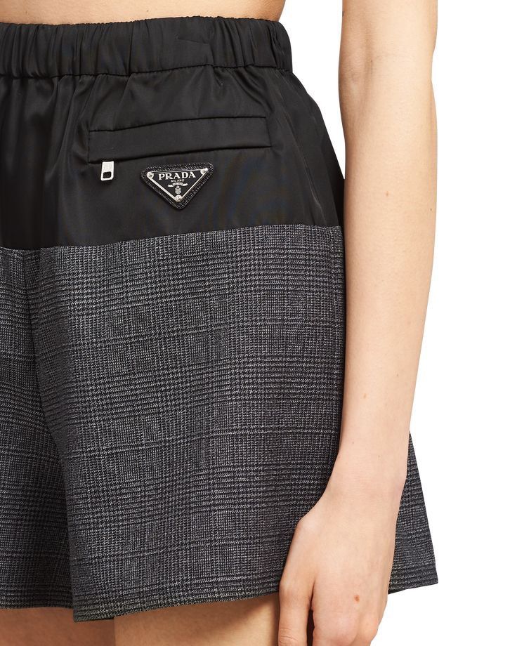 SOLDD Prada ReNylon and Wool Houndstooth Shorts (Category: Shorts) located in Santa Rosa. Submitted by jamrose (Listing ID 1468561952, Image 1). Description: L 14 W25-28 (Made in Romania) - Condition: with original tags attached - Design: Mixed-media style with black Re-Nylon upper and grey wool houndstooth tweed lower - Features: Comfortable elastic waistband, hip zip pocket, and signature enamel triangle logo plaque.