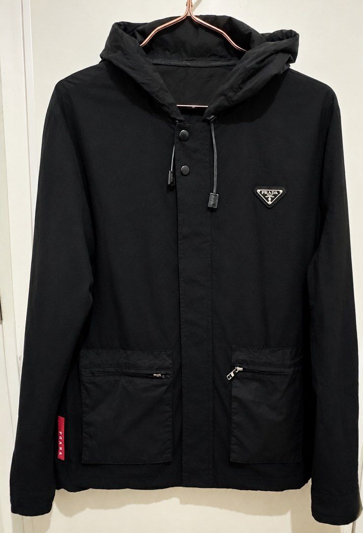 PRADA Re-Nylon Hooded Jacket (Category: Luxury Apparel) located in Manila. Submitted by manifestd (Listing ID 1468512686, Image 2). Description: PRADA Re-Nylon Hooded Jacket ✔️M-L, 20.5x26.5, soft and lightweight ✔️A blend of sportswear and luxury ✔️With the iconic enamel logo plaque, drawstring hood, zip and snap on fastening ✔️Preloved in great condition, unisex ✔️Lalamove/J&T ready *also posted on my 2nd account: manifestd.