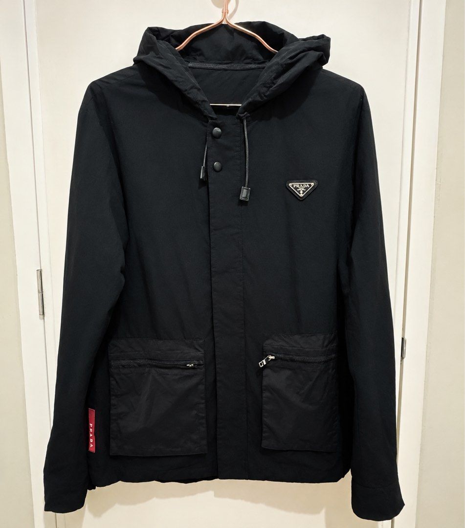 PRADA Re-Nylon Hooded Jacket (Category: Luxury Apparel) located in Manila. Submitted by manifestd (Listing ID 1468512686, Image 1). Description: PRADA Re-Nylon Hooded Jacket ✔️M-L, 20.5x26.5, soft and lightweight ✔️A blend of sportswear and luxury ✔️With the iconic enamel logo plaque, drawstring hood, zip and snap on fastening ✔️Preloved in great condition, unisex ✔️Lalamove/J&T ready *also posted on my 2nd account: manifestd.