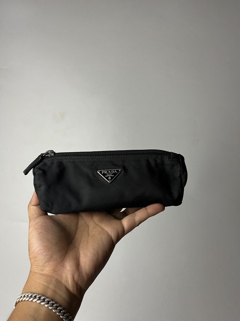 Prada Tessuto Nylon Cylindrical Pouch (Category: Luxury Accessories) located in Manila. Submitted by streetsavvy (Listing ID 1468589257, Image 2). Description: Prada Tessuto Nylon Cylindrical Pouch Width: 7” Height: 2.5” Depth: 3” Measured in Inches A classic vintage Prada piece crafted from signature black Tessuto technical nylon. Designed in a sleek, compact cylindrical silhouette, this versatile pouch works as a pencil case, travel cosmetic ba