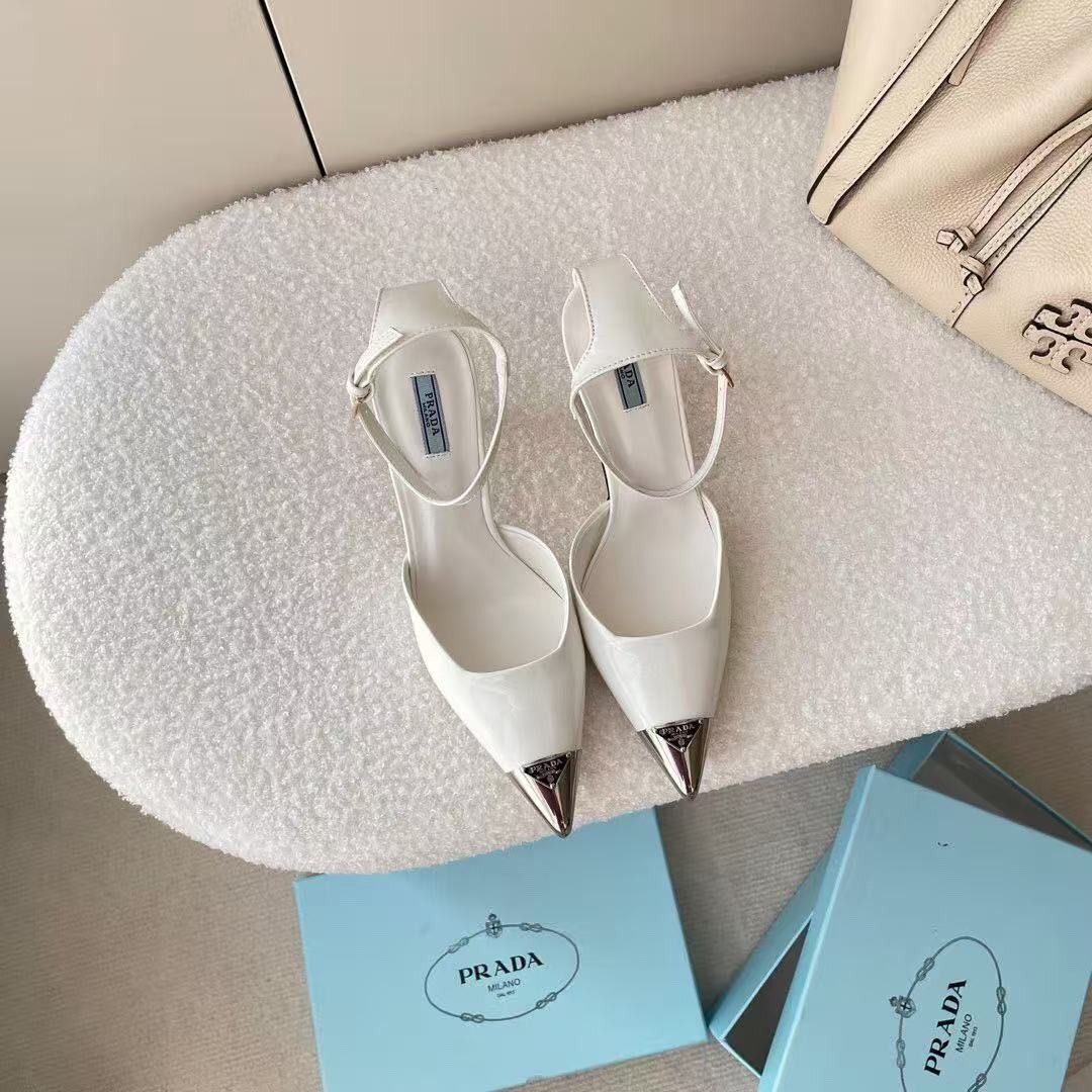 Prada White Slingback Heels with Silver Toe Cap (Category: Heels) located in Malabon City. Submitted by ojaswibent53454 (Listing ID 1468558431, Image 3). Description: - Brand: Prada - Style: Slingback stiletto heels with adjustable ankle strap buckle closure - Color: Clean white leather finish - Details: Pointed toe with silver-tone metal toe cap and signature Prada logo plaque - Inclusions: Original light blue Prada branded box as pictured - Con