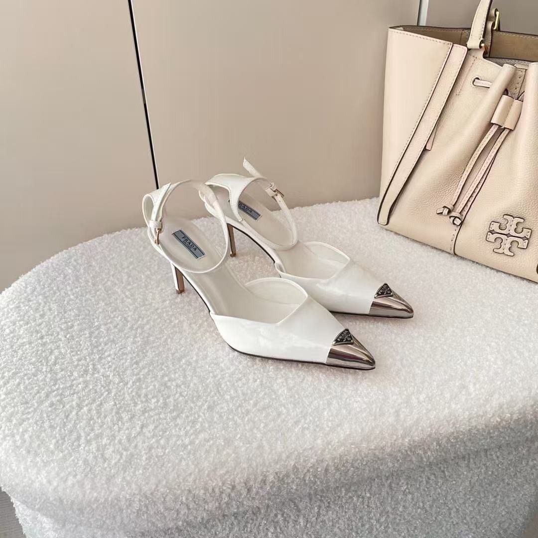 Prada White Slingback Heels with Silver Toe Cap (Category: Heels) located in Malabon City. Submitted by ojaswibent53454 (Listing ID 1468558431, Image 1). Description: - Brand: Prada - Style: Slingback stiletto heels with adjustable ankle strap buckle closure - Color: Clean white leather finish - Details: Pointed toe with silver-tone metal toe cap and signature Prada logo plaque - Inclusions: Original light blue Prada branded box as pictured - Con