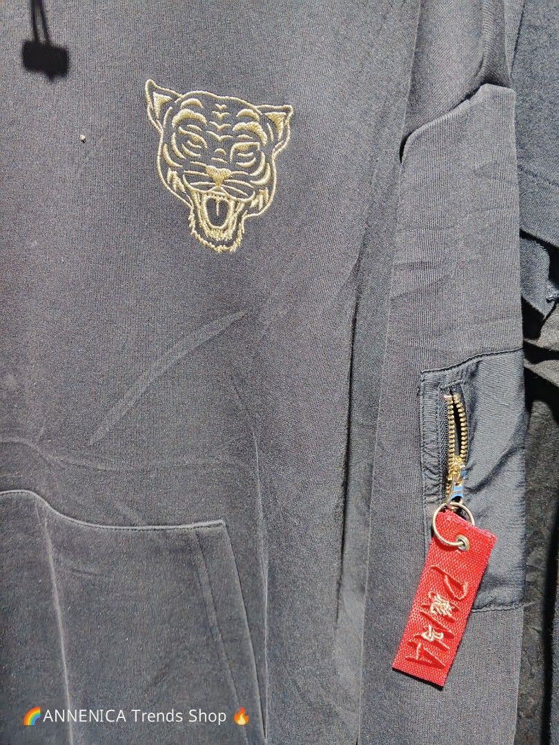 PUMA GOLD TIGER HOODIE (Category: Coats, Jackets and Outerwear) located in Bulacan. Submitted by annenicathriftthriftlang (Listing ID 1468516193, Image 3). Description: *PUMA GOLD TIGER HOODIE - BLACK* *Size L on tag - P400 ONLY!* *DIMES:* - Width: 23 inch (pit to pit) - Length: 28 inch - Sleeve: 24 inch - Size on tag: L - Fit Medium to Large - Fit: Oversized / Streetwear *DETAILS:* - Gold embroidered Tiger head sa chest - maangas! - Gold drawstr