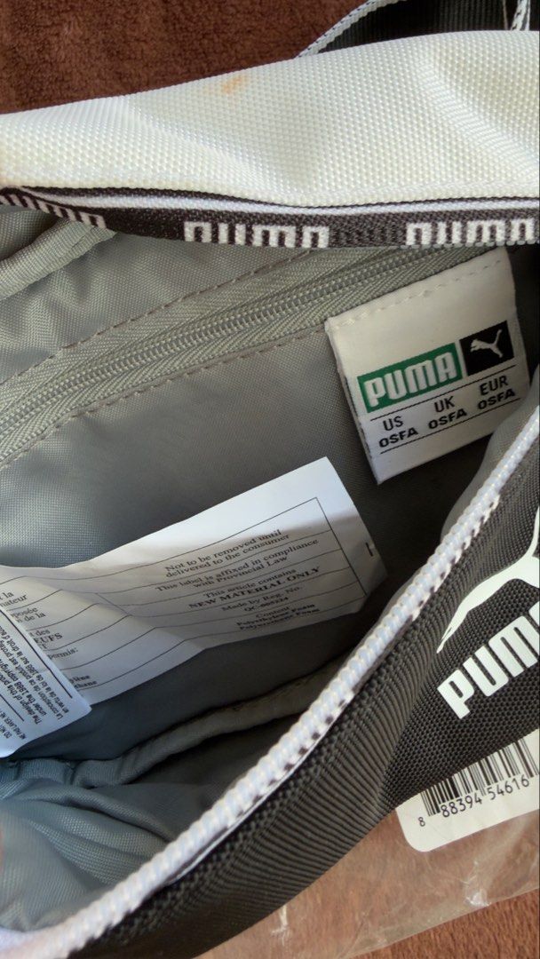 Puma Hip Pack Bum Bag Black White (Category: Babies & Kids Fashion) located in Cainta. Submitted by sixteenfive29 (Listing ID 1468606732, Image 3). Description: - Brand: Puma - Color: Classic Black and White - Size: Standard OSFA (One Size Fits All) - Features: Adjustable strap with buckle, zippered main compartment, and inner tag - Condition: Brand new with original hang tags in packaging; has a small, faint orange stain on the white fabric near