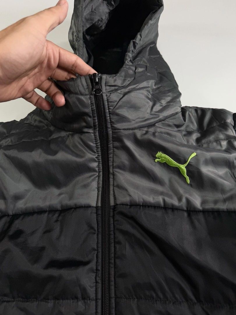 PUMA PUFFER (Category: Coats, Jackets and Outerwear) located in Valenzuela. Submitted by veriez_gems (Listing ID 1468624332, Image 3). Description: Brand: Puma Size: Medium (M) Style / Type: Puffer / Quilted hooded jacket with a full-zip front and attached hood Colorway: Two-tone black and dark grey body with a bright lime/neon green embroidered Puma cat logo on the chest Features: Quilted insulated design for warmth Full-length front zipper Dual