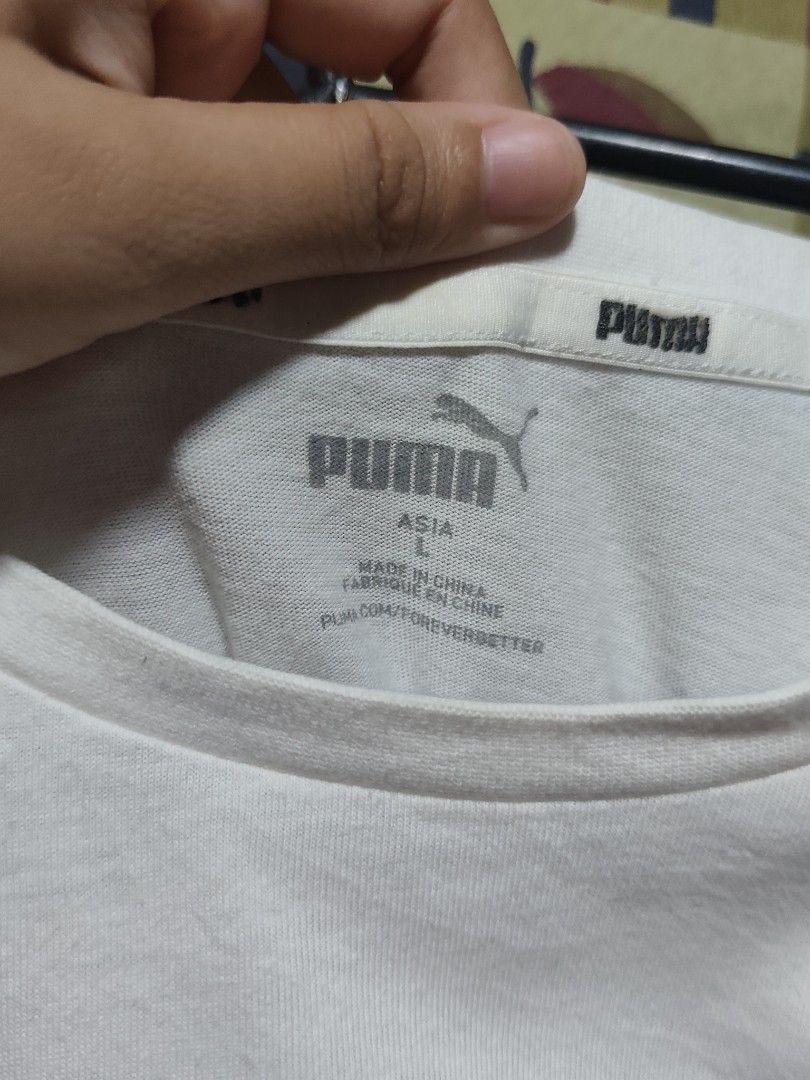 PUMA white shirt with logo (Category: Formal Shirts) located in Bauang. Submitted by chrisquinto2004 (Listing ID 1468523476, Image 2). Description: - Brand: PUMA - Color: White with black logo - Size: Large (Asia L) - Features: Classic chest logo and branded sleeve cuffs - Condition: Good pre-owned condition, clean and well-kept - Style: Casual / Athletic wear.