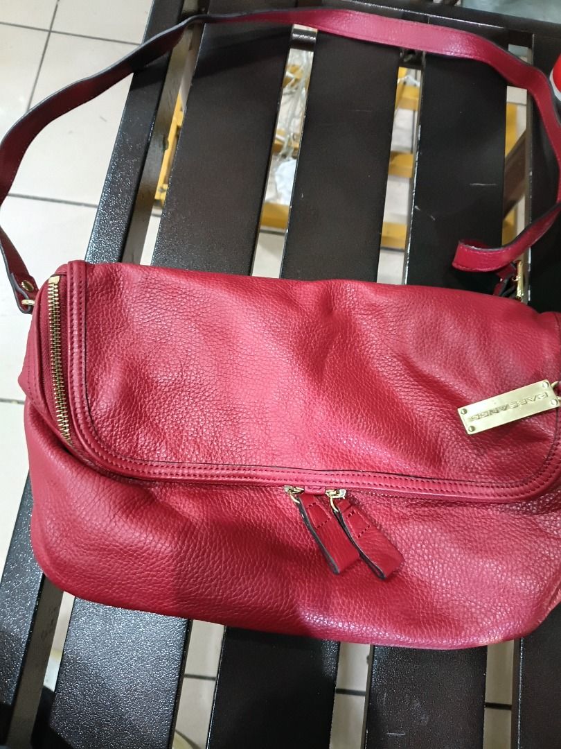 Rabeanco Cube Crossbody Bag Red Pebbled Leather (Category: Cross-body Bags) located in Caloocan City. Submitted by harrypotter0215 (Listing ID 1468519495, Image 1). Description: - Brand: Rabeanco - Material: Premium red pebbled leather - Style: Fold-over triangular slouch bag with shoulder strap - Hardware: Elegant gold-tone hardware and front brand tag - Features: Double zip details and a roomy interior - Condition: Great everyday purse for carr