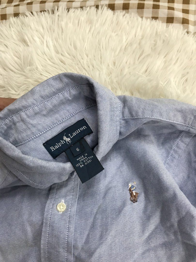 Ralph Lauren Light Blue Button-Down Shirt Size 6 (Category: Babies & Kids Fashion) located in Aloguinsan. Submitted by jayhooukay (Listing ID 1468508686, Image 2). Description: - Brand: Ralph Lauren - Color: Light Blue - Size: 6 - Material: 100% Cotton (textured oxford weave) - Features: Classic long sleeves, button cuffs, standard collar, and iconic embroidered pony logo on the chest - Condition: Excellent pre-loved condition - Perfect for work,