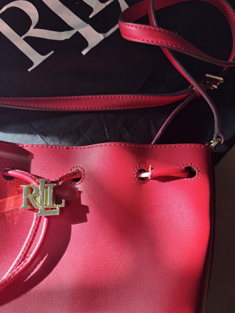 Ralph Lauren Red Leather Bucket Bag (Category: Luxury Bags & Wallets) located in Pasig City. Submitted by _aboutagal (Listing ID 1468574885, Image 2). Description: - Brand: Lauren Ralph Lauren - Style: Ralph Lauren Andie 25 Full grain Red Leather Bucket Bag - Hardware: Gold-tone RL metal on drawstring closure - Strap: Adjustable shoulder strap - Inclusions: Matching black dust bag and original care card tag - Condition: Clean red finish throughou