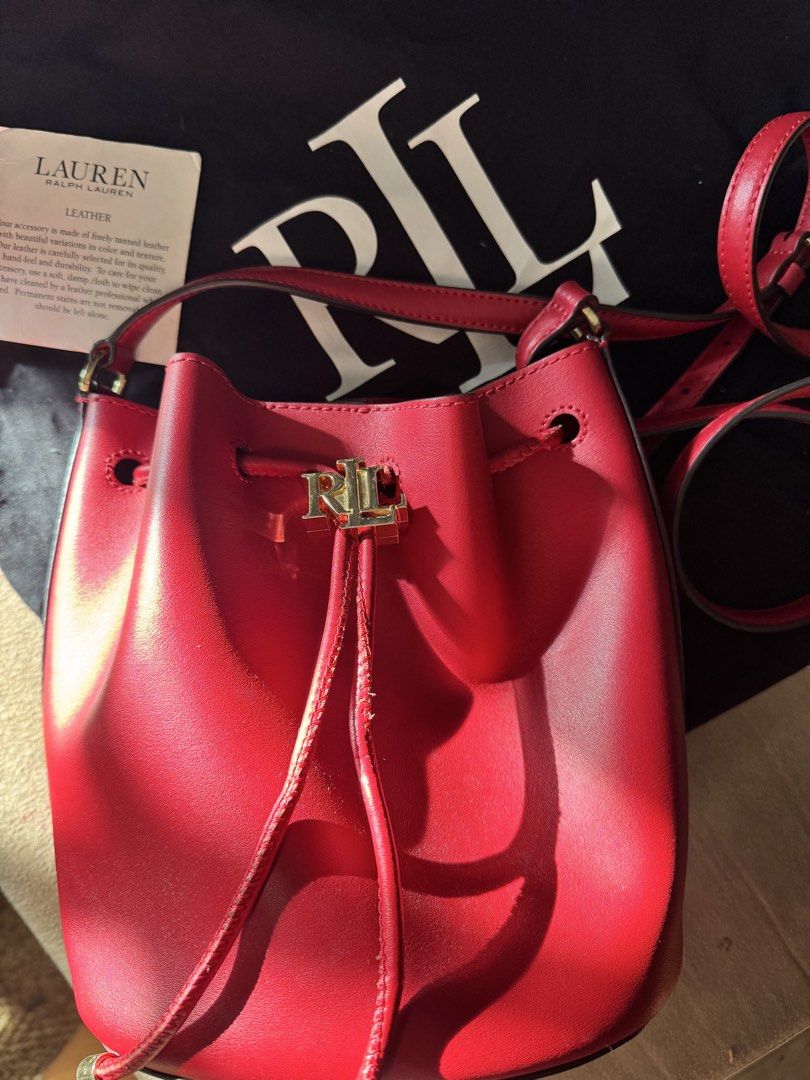 Ralph Lauren Red Leather Bucket Bag (Category: Luxury Bags & Wallets) located in Pasig City. Submitted by _aboutagal (Listing ID 1468574885, Image 3). Description: - Brand: Lauren Ralph Lauren - Style: Ralph Lauren Andie 25 Full grain Red Leather Bucket Bag - Hardware: Gold-tone RL metal on drawstring closure - Strap: Adjustable shoulder strap - Inclusions: Matching black dust bag and original care card tag - Condition: Clean red finish throughou