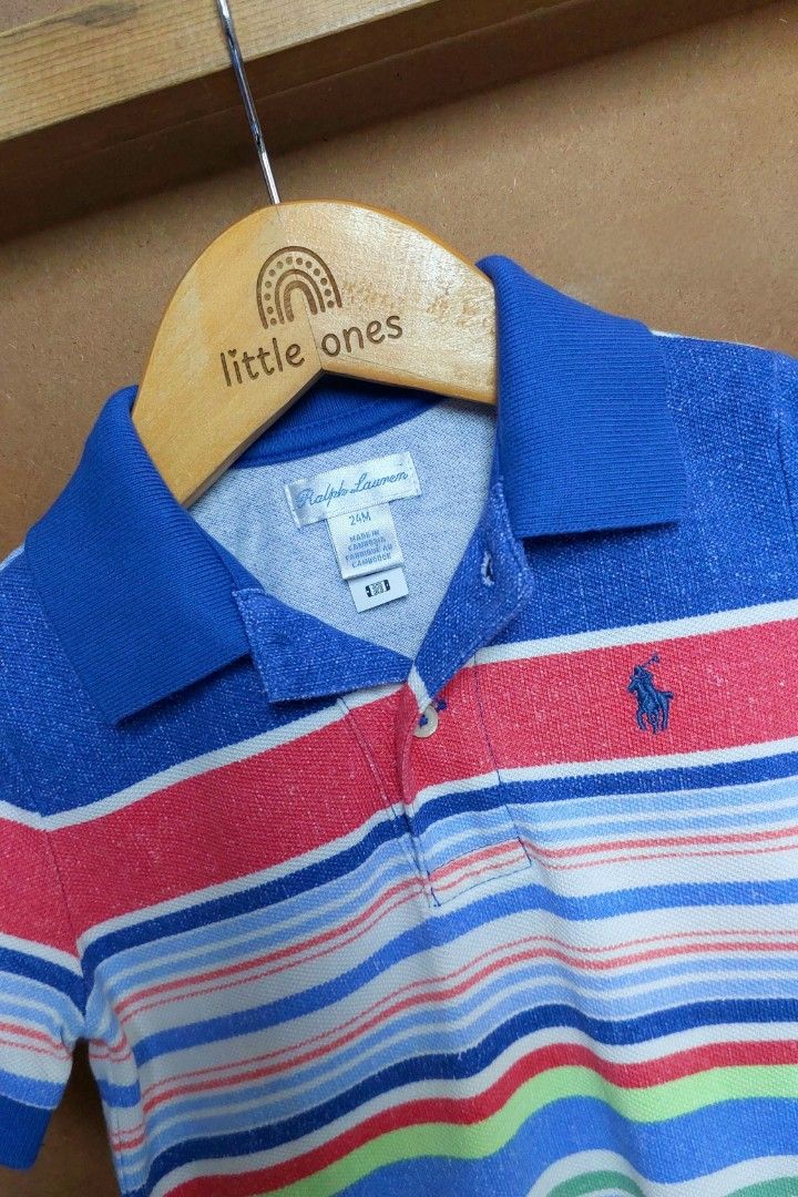 Ralph Lauren Striped Polo Romper (Category: Babies & Kids Fashion) located in Caloocan City. Submitted by clairyyyyy (Listing ID 1468665505, Image 2). Description: - Brand: Ralph Lauren - Size: 24 Months - Material: Soft cotton polo fabric - Design: Colorful all-over stripes with blue polo collar and short sleeves - Details: Iconic embroidered pony logo on chest, button placket - Convenience: Snap closure at the bottom for easy diaper changes - O
