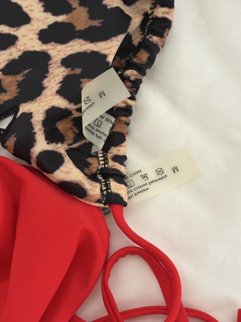 Red and Leopard Print Reversible String Bikini (Category: Bikinis & Swimsuits) located in Las Pinas. Submitted by thriftedfinds_ (Listing ID 1468501825, Image 2). Description: - 2-in-1 design: solid red on one side, bold leopard print on the other - Fully adjustable halter neck, back ties, and tie-side bottoms for a custom fit - Size M with original tags still attached - Material: 82% nylon, 18% elastane - Condition: Brand new and clean RFS: DOES