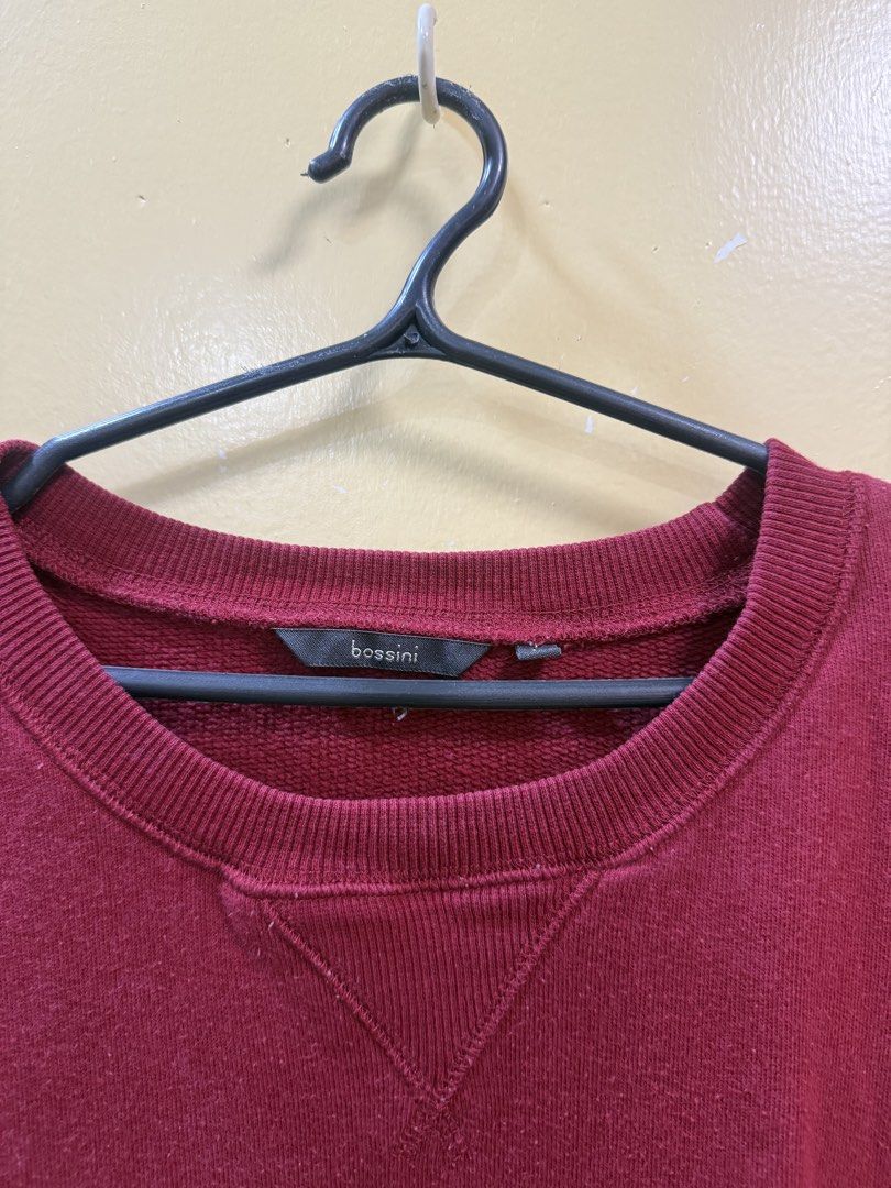 Red Bossini Sweatshirt (Category: Coats, Jackets and Outerwear) located in Makati City. Submitted by shoprory (Listing ID 1468591456, Image 2). Description: - Brand: Bossini - Color: Maroon - Style: Crewneck with classic triangle insert - Fit: Relaxed fit with long sleeves - Details: Ribbed collar, cuffs, and hem - Material: Warm and cozy, ideal for casual days or layering.