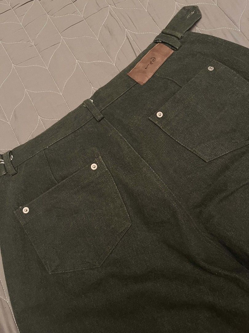 RED Dark Green Raw Denim Pants (Category: Jeans) located in Manila. Submitted by safelion-a2982f (Listing ID 1468603953, Image 3). Description: Dark green denim pants from RED. Wide leg cut with structured waistline and unique metal button accents across the front waistband. Two back pockets with button details and a brown leather patch on the back. Sturdy fabric, clean hems. Ready to wear. DIMES W(27-33) adjustable buttons L(41) T(15) H(10.5) .