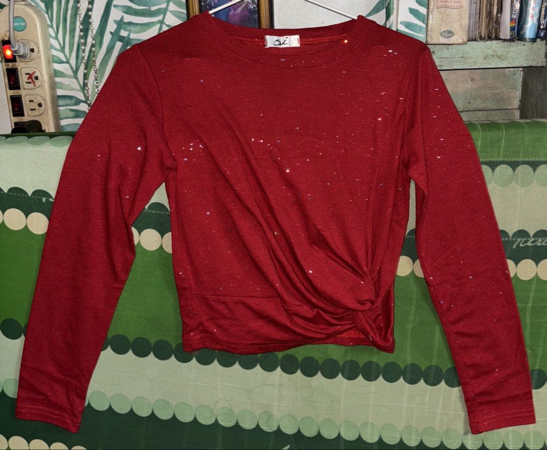 Red Long Sleeve Twist Crop Top (Category: Longsleeves) located in Manila. Submitted by whatspoppin3000 (Listing ID 1468585327, Image 1). Description: - Color: Red with subtle glitter details - Design: Round neckline with a chic twisted hem on the lower right - Fit: Cropped length, standard fit - Material: Soft and comfortable fabric - Condition: Brand new with clean tag attached - Versatility: Easy to style for casual days or night outs with high