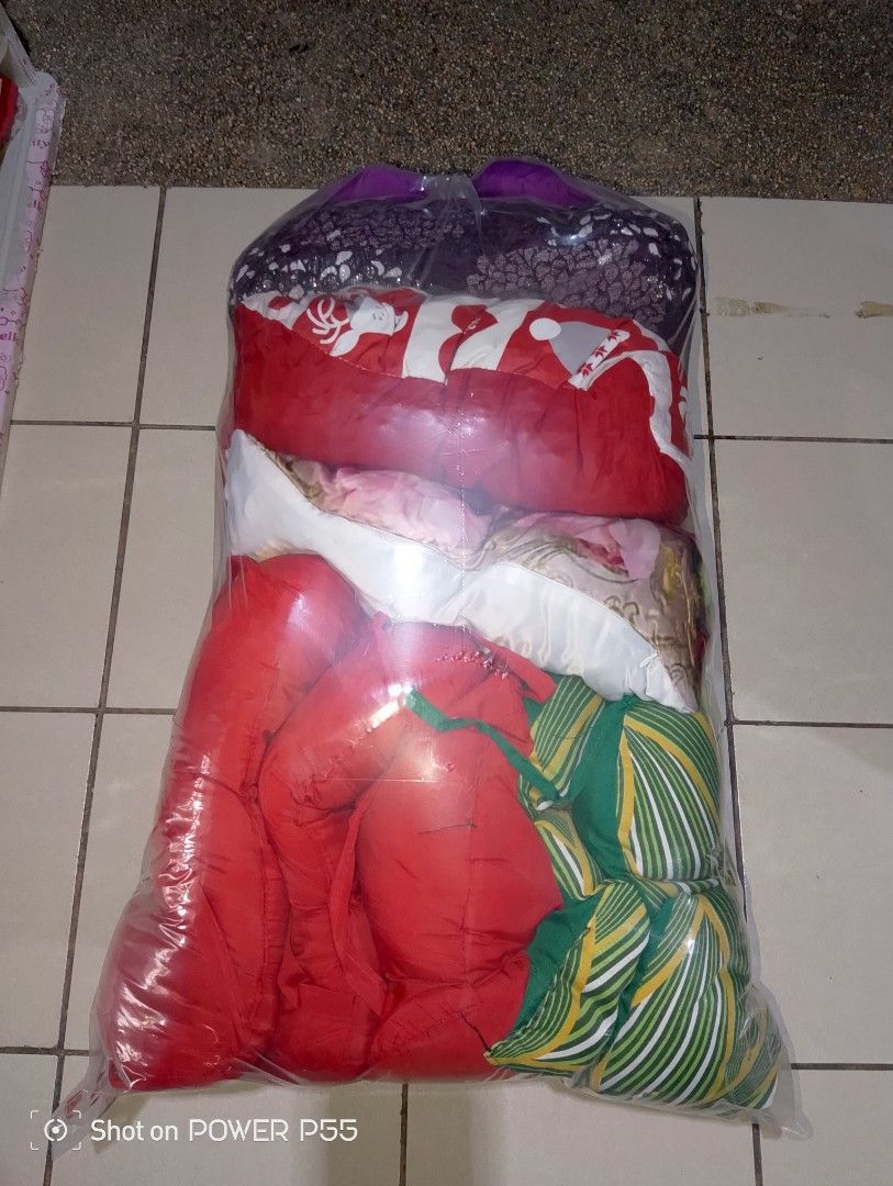 Red mattress pad with assorted patterned cushions and neck pillows (Category: Bedding & Towels) located in Manila. Submitted by mendozajar47609 (Listing ID 1468507965, Image 2). Description: FOR SALE P450 WYSIWYG MATRESS GOOD CONDITION PILLOWS May mga tastas o butas kyo nlng po mgtahi (Bago laba) pm or text 0967 076 2294 LALAMOVE OR GRAB kayo po mgbook pg nandito na rider tsaka send payment thru gcash - Bundle includes 1 red mattress pad and a la