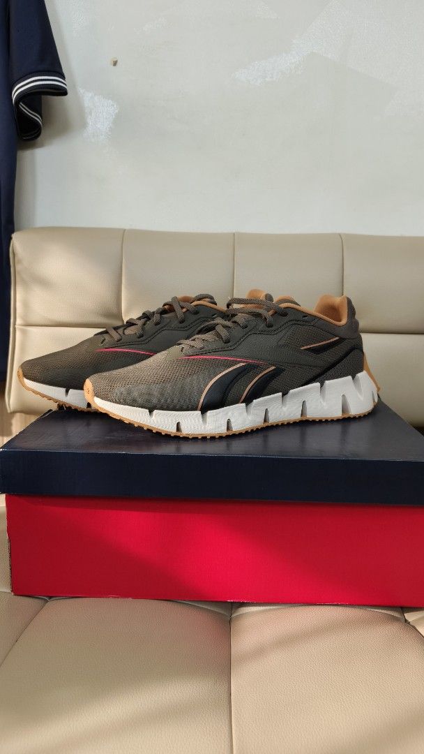 Reebok Zig Dynamica 4 (Category: Sneakers) located in Manila. Submitted by jaysold (Listing ID 1468569309, Image 2). Description: Reebok Zig Synergy Size 9.5US Slightly negotiable - Colorway: Olive green, black, and brown - Sole: Iconic white zigzag midsole with a durable gum rubber outsole for solid grip - Condition: Brand new, never worn, pristine inside the box - Packaging: Includes original red and blue shoebox - Ideal Use: Great, stylish eve