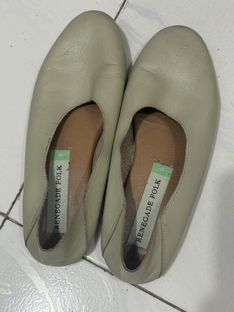 Renegade Folk Leather Flats Size 8 (Category: Flats & Sandals) located in Mandaluyong City. Submitted by trovebya (Listing ID 1468584329, Image 1). Description: - Brand/Item: Renegade Folk leather slip-on flats - Color: Beige with brown inner lining - Size: 8 - Features: Soft textured upper, branded insoles - Condition: Minor scuff marks and wear at the front toes - Style: Comfortable everyday flats, easy to pair with casual outfits.