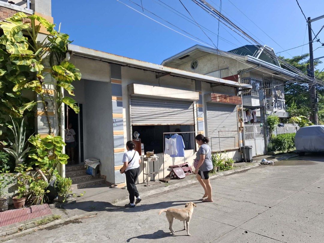 Residential House Property (Category: Construction & Building Materials) located in Manila. Submitted by bunbun__ (Listing ID 1468708551, Image 1). Description: - Property Type: Residential building with multi-story dwelling - Ground Floor: Features secure roller shutters and a spacious porch area - Location: Accessible along a paved concrete street with complete utility lines - Condition: Good, sturdy structure—ready for immediate move-in or cus
