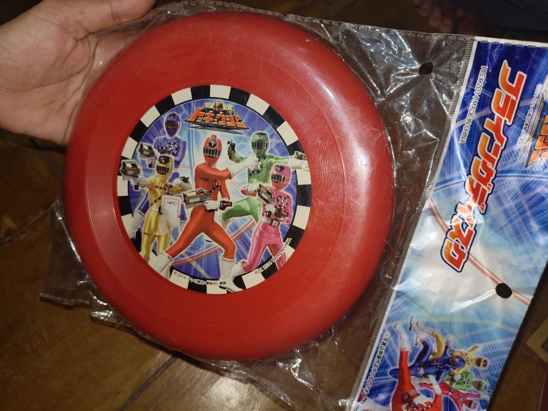 Ressha Sentai ToQger Flying Disc Frissbee (Category: Action & Battle Toys) located in Daanbantayan. Submitted by mvs08_collectibles (Listing ID 1468659690, Image 1). Description: - Official Plex 2014 release featuring Ressha Sentai ToQger - Brand new and still sealed in original plastic packaging - Vibrant red flying disc with a classic black and white checkered border - Authentic Japanese tokusatsu collectible toy item - Perfect addition for Sup