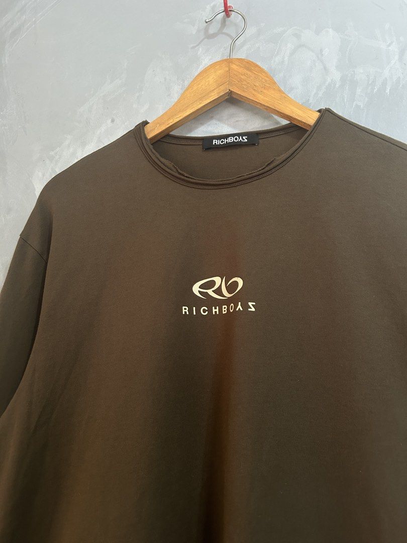 Richboyz Brown Long Sleeve Shirt (Category: Coats, Jackets and Outerwear) located in Tarlac. Submitted by thrift_genius (Listing ID 1468506510, Image 3). Description: - Brand: Richboas - Color: Brown - Style: Long sleeve crewneck with relaxed fit - Details: Small chest logo, large back graphic, and trendy distressed raw-edge collar and cuffs - Condition: Worn a few times, fabric in solid shape.