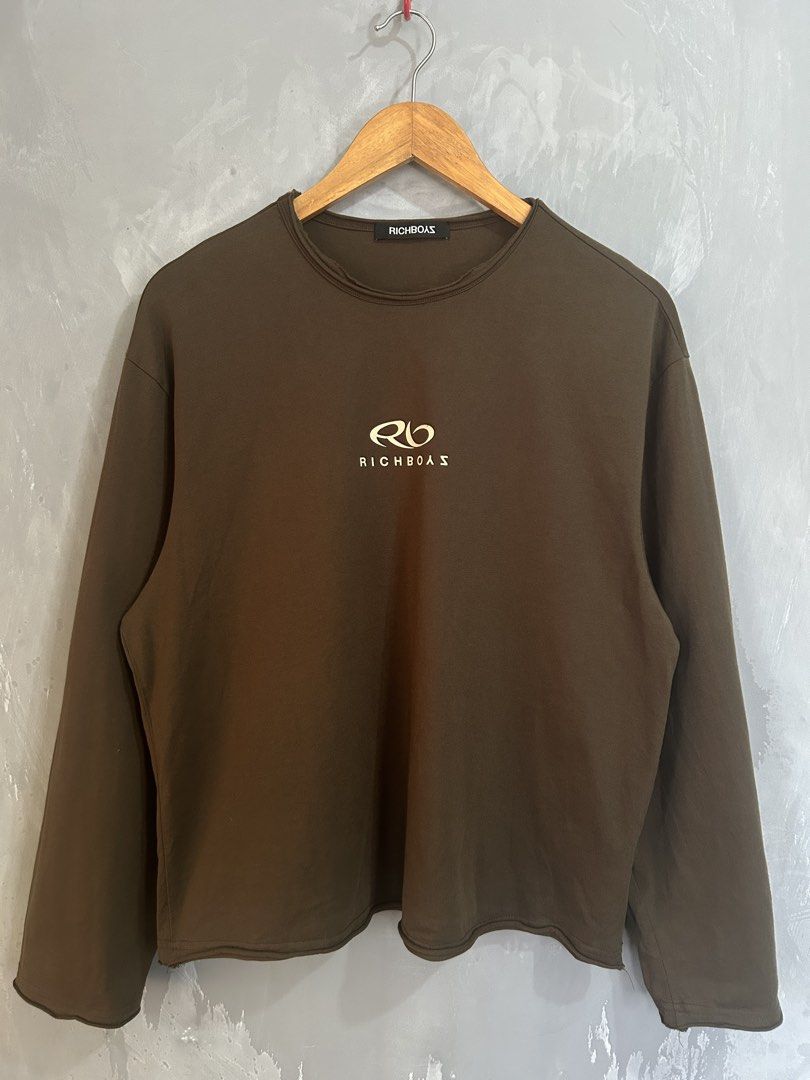 Richboyz Brown Long Sleeve Shirt (Category: Coats, Jackets and Outerwear) located in Tarlac. Submitted by thrift_genius (Listing ID 1468506510, Image 2). Description: - Brand: Richboas - Color: Brown - Style: Long sleeve crewneck with relaxed fit - Details: Small chest logo, large back graphic, and trendy distressed raw-edge collar and cuffs - Condition: Worn a few times, fabric in solid shape.