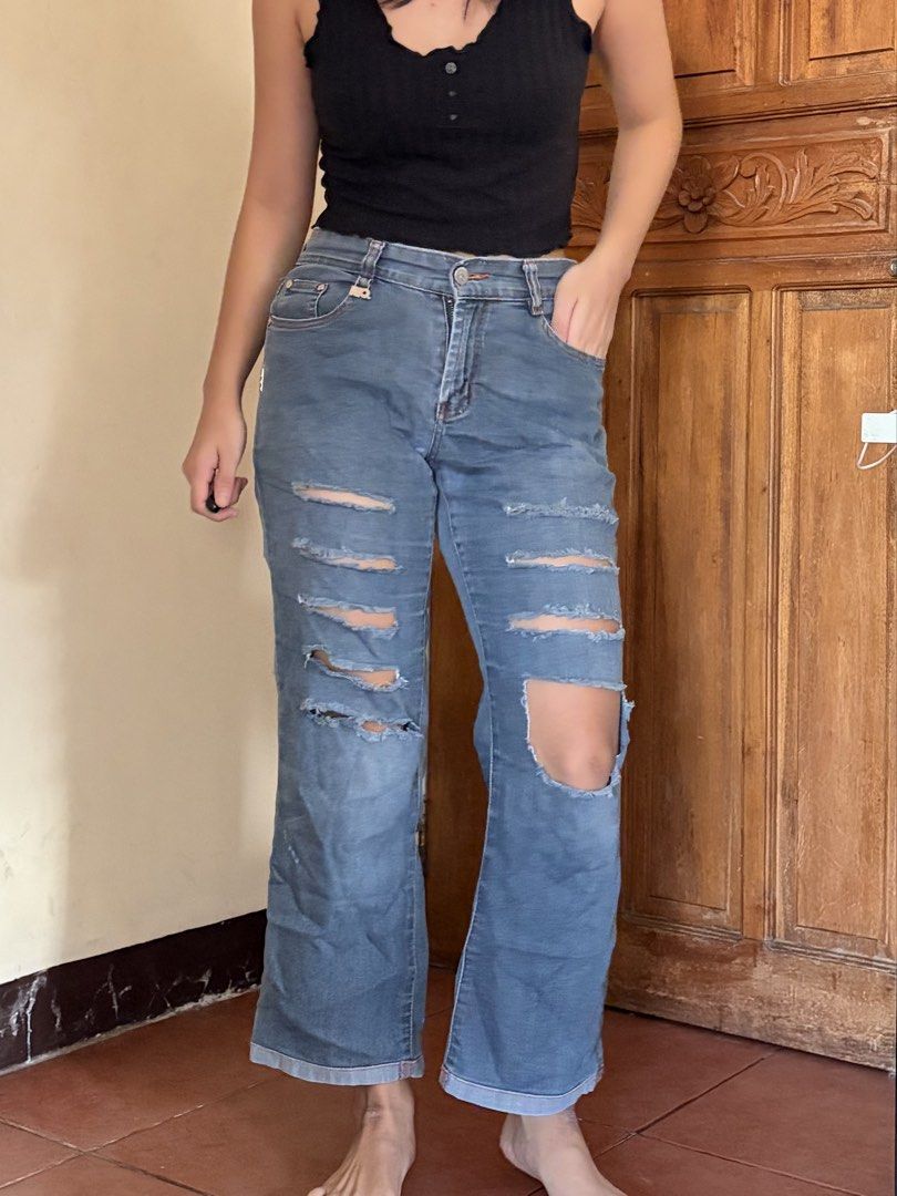 Ripped Blue Denim Jeans (Category: Jeans) located in Pasig City. Submitted by catherinea38704 (Listing ID 1468627204, Image 2). Description: - Style: Casual mid-rise blue denim jeans - Detailing: Heavy front distressing with multiple horizontal rips and a bold knee cutout - Hem: Trendy cuffed hems at the bottom - Fit: Comfortable and great for everyday wear - Condition: Excellent Waistline 26-27inches Location: Caniogan Pasig.