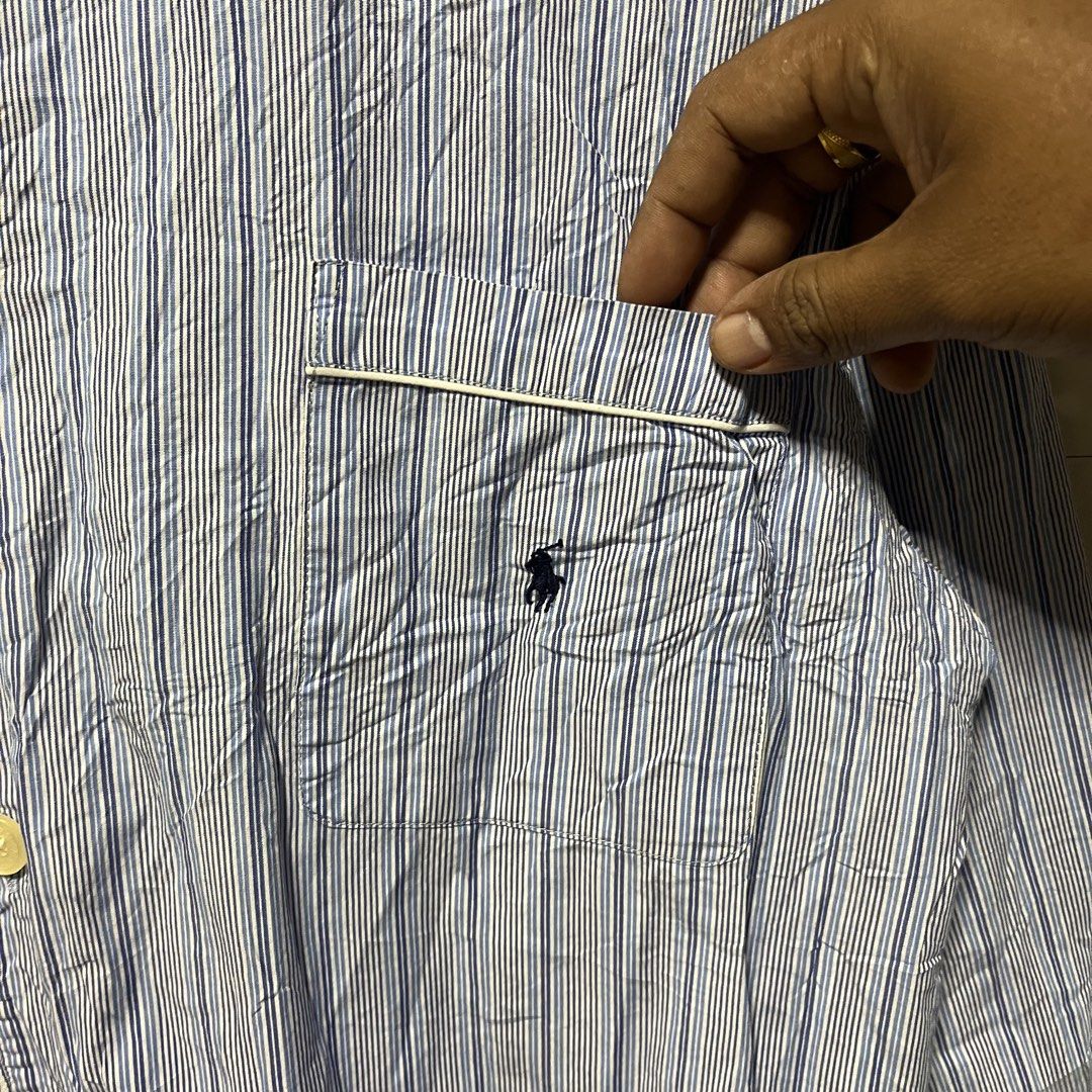 RL GOLD TAG (Category: Tshirts & Polo Shirts ) located in Binangonan. Submitted by nhogsmapula-24860 (Listing ID 1468584644, Image 2). Description: This is a long-sleeve, blue-and-white vertical striped cotton button-up sleepwear or lounge shirt by Polo Ralph Lauren featuring a chest pocket with an embroidered logo..