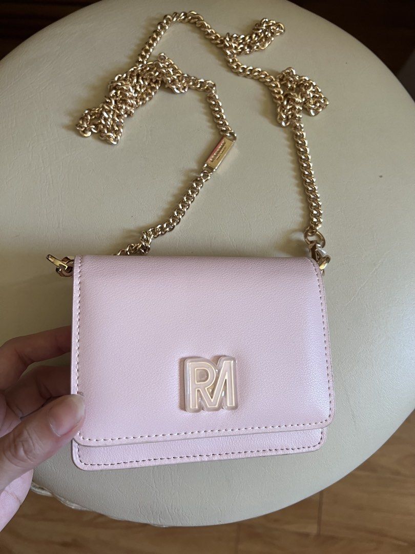 ROBINMAY Pink Crossbody Bag Chain Strap (Category: Cross-body Bags) located in Rizal. Submitted by s0apandglory (Listing ID 1468561226, Image 1). Description: - Brand: ROBINMAY Never used bought in Taiwan - Color: Pastel Pink faux leather - Hardware: Gold-tone chain strap with branded metal tag and clear RM logo - Closure: Front flap with magnetic snap - Interior: Includes card slots and a zipped compartment - Size: Mini/Compact, ideal for carryi