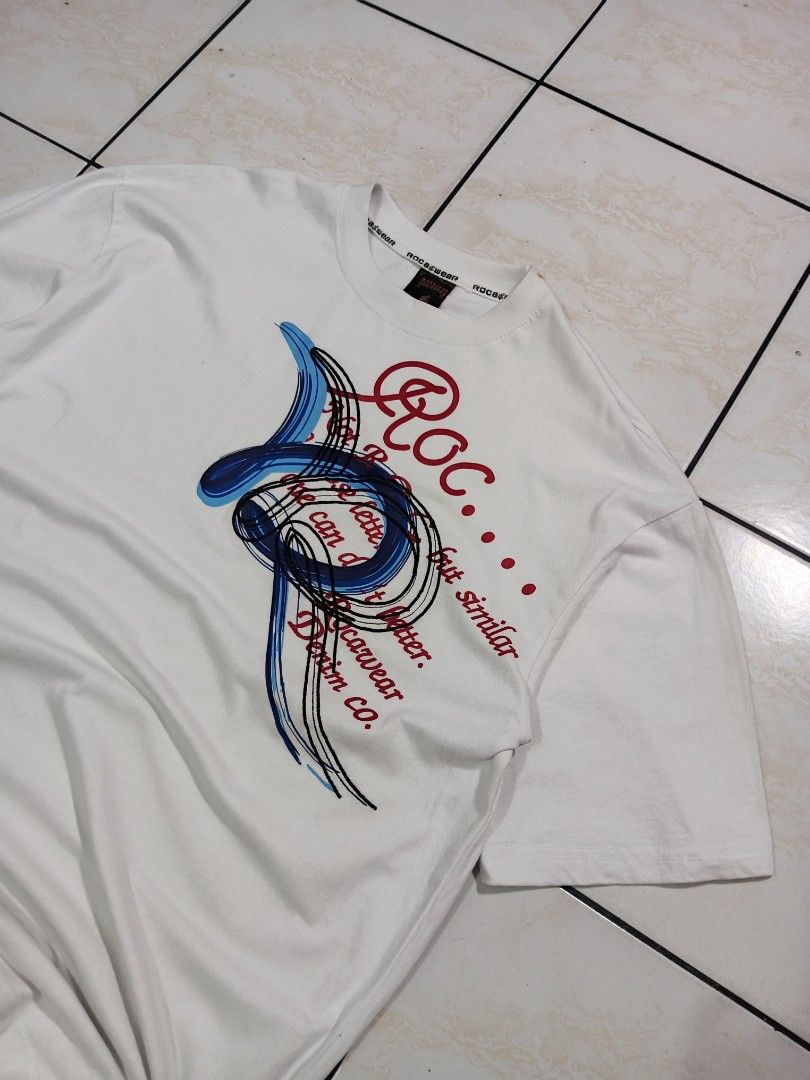 ROCAWEAR T-SHIRT (Category: Tshirts & Polo Shirts ) located in Taguig. Submitted by wst.fnds (Listing ID 1468685068, Image 2). Description: ROCAWEAR WHITE T-SHIRT GOOD CONDITION BIG EMBROID AND PRINTED DESIGN ISSUE MULTIPLE SMALL PINHOLE W:23.5 / L:31 💸: 199.