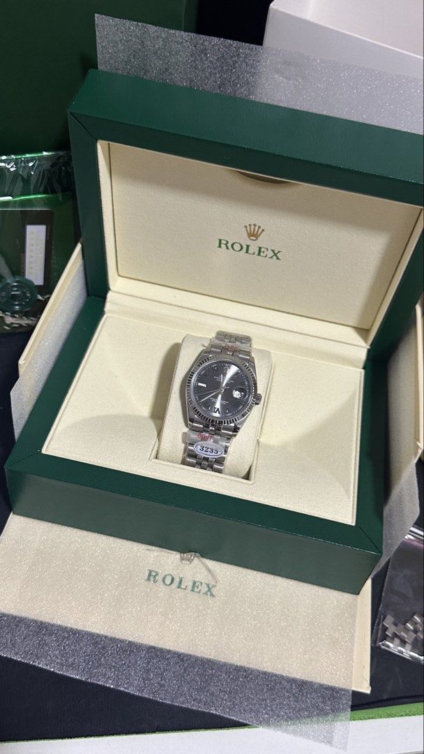 Rolex Datejust 36 "Wimbledon" Dial (Midtier) (Category: Luxury Watches) located in Balanga. Submitted by garahehub (Listing ID 1468501538, Image 2). Description: - Model Style: Datejust 36 - Tier / Quality: Midtier - Dial: Slate Grey “Wimbledon” Dial with Green Roman Numerals - Movement: Automatic Movement (3235 Engraved) - Bezel: Fluted Bezel - Bracelet: Jubilee Bracelet (904L Steel Marked) - Glass: Sapphire Glass with Cyclops Date Lens - Inclus