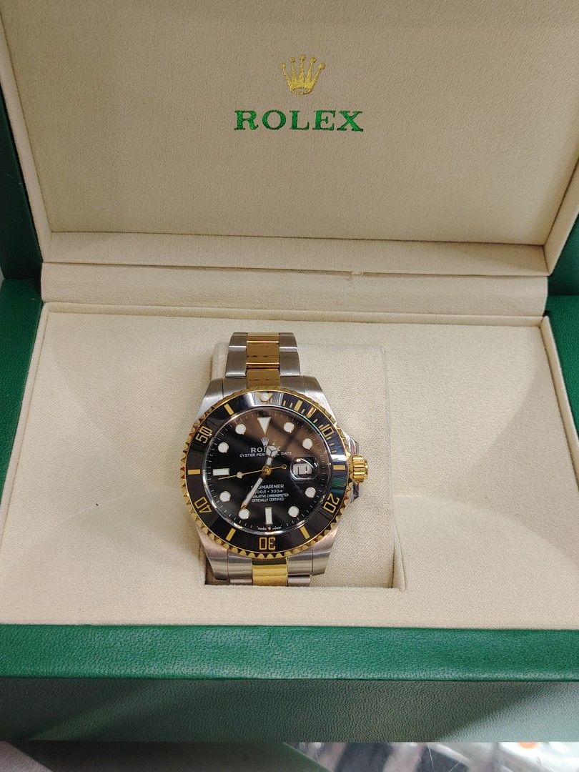 Rolex Submariner Date Two Tone Watch (Category: Luxury Watches) located in Quezon City. Submitted by gdycdayao (Listing ID 1468502632, Image 1). Description: - Model: Rolex Submariner Date Two-Tone (Gold & Stainless Steel) - Dial: Black dial with date window and cyclops lens at 3 o'clock - Bezel: Rotating bezel - Bracelet: Oyster bracelet with fold-over clasp and crown logo - Condition: Keeps accurate time - Inclusion: Original green presentation
