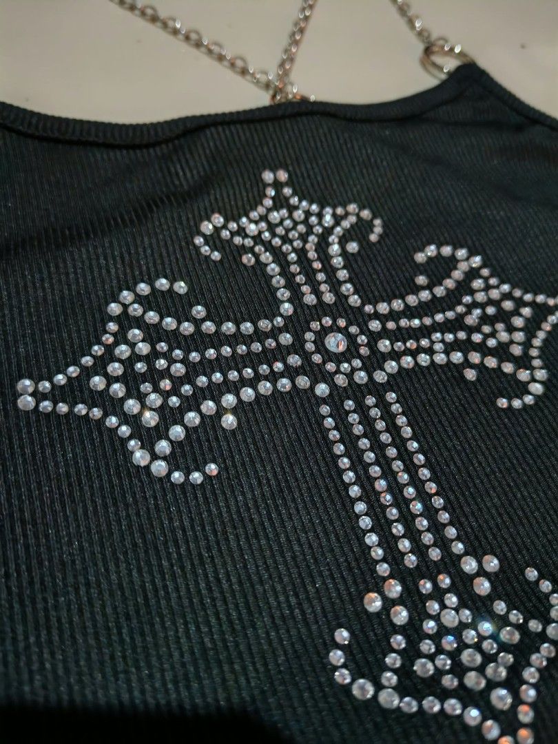 ROMWE Black Rhinestone Cross Chain Strap Crop Top (Category: Sleeveless) located in Malolos. Submitted by krissalayne (Listing ID 1468583246, Image 2). Description: - Brand: ROMWE - Condition: Brand new with original tags attached - Style: Ribbed knit crop top - Details: Sparkling rhinestone cross graphic on the front - Straps: Edgy silver chain straps attached with metal rings - Perfect for: Casual outings, parties, or concerts.