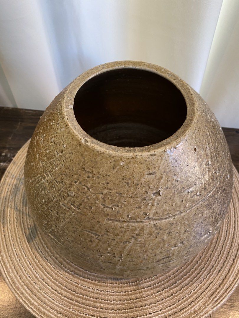 Round Textured Brown Ceramic Vase (Category: Vases & Decorative Bowls) located in San Pedro. Submitted by jingay81 (Listing ID 1468708696, Image 3). Description: - Type: Round ceramic vase - Color/Finish: Earthy brown with speckled glaze - Design: Textured exterior with horizontal scored lines - Size: Approx. 7 inches tall - Best for: Dried branches or floral arrangements - Style: Neutral tone that matches most home decor.