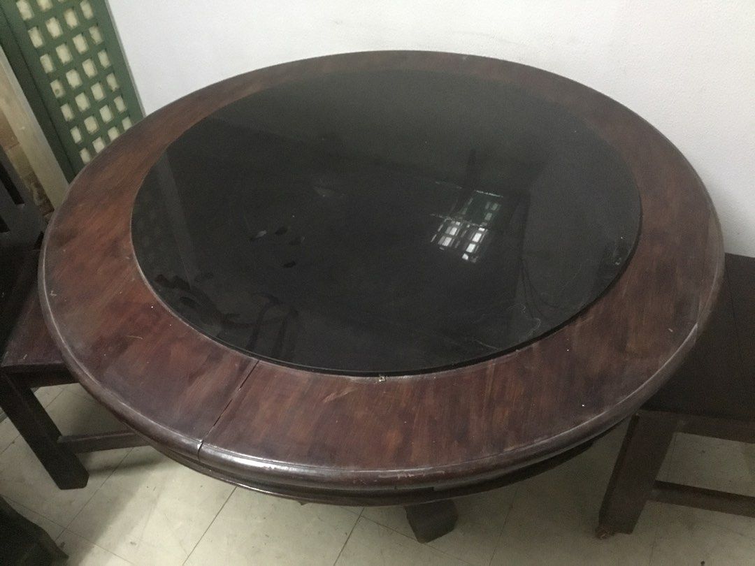 Round Wooden Dining Table with Chairs (Category: Tables & Sets) located in Manila. Submitted by roberto.enriquez (Listing ID 1468689718, Image 3). Description: - Dark wood round dining table - Stylish black glass top insert in the middle - Includes matching dark wooden chairs with comfortable slatted backs - Sturdy pedestal base design for maximum support - Normal wear on wood surfaces from regular use - Pick up only Diameter Height .