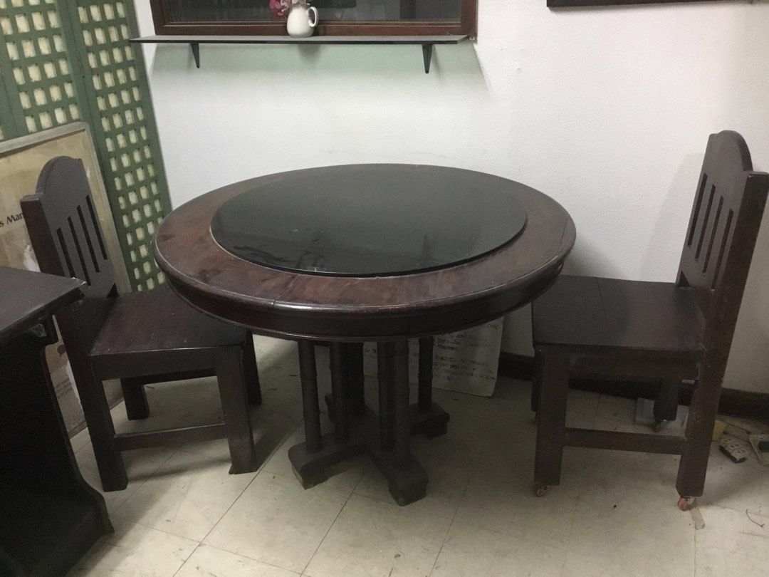 Round Wooden Dining Table with Chairs (Category: Tables & Sets) located in Manila. Submitted by roberto.enriquez (Listing ID 1468689718, Image 1). Description: - Dark wood round dining table - Stylish black glass top insert in the middle - Includes matching dark wooden chairs with comfortable slatted backs - Sturdy pedestal base design for maximum support - Normal wear on wood surfaces from regular use - Pick up only Diameter Height .