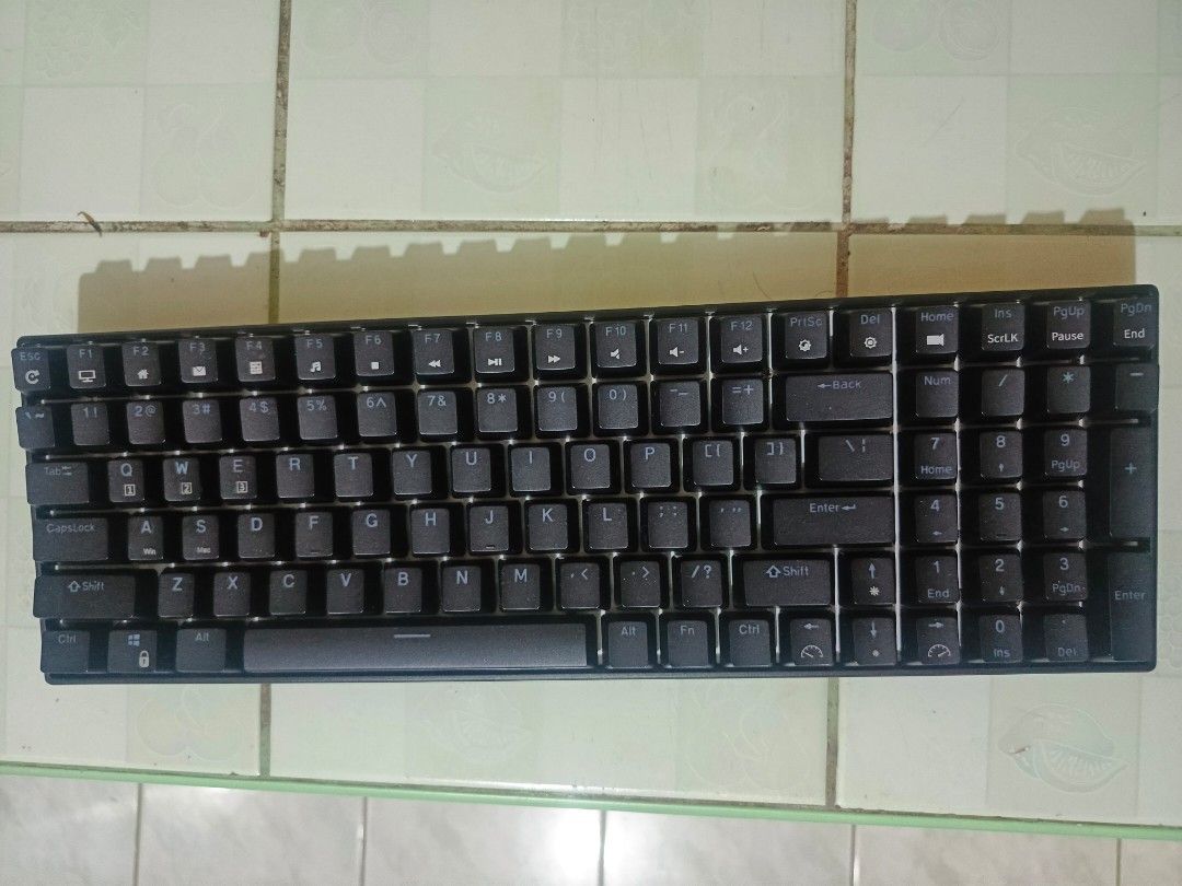 Royal Kludge RK100 Wireless Mechanical Keyboard (Category: Computer Keyboard) located in Marikina City. Submitted by sellingpersonalpc (Listing ID 1468678687, Image 1). Description: - Brand/Model: Royal Kludge RK100 - Color: Sleek black plastic housing - Connectivity: Wireless with USB receiver stored securely in the bottom slot - Ergonomics: Adjustable flip-out feet on the back corners - Power Rating: 5V = 200mA - FCC ID: 2A4MQ-RK100 - Origin: M
