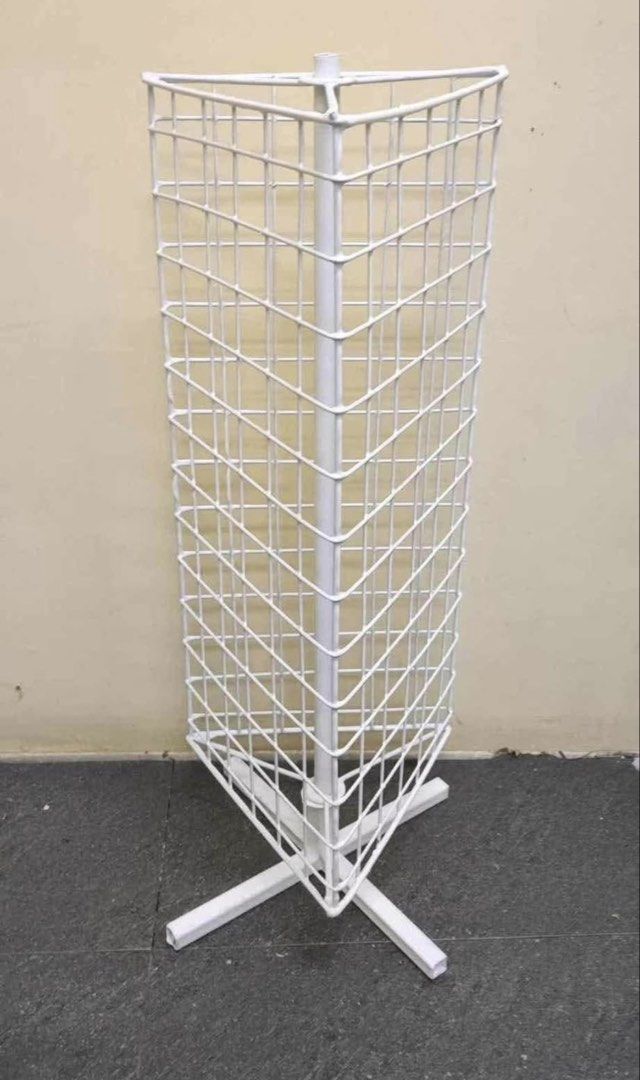 RUSH! White rotating wire mesh display rack floor stand (Category: Shelves, Cabinets & Racks) located in Makati City. Submitted by kimfranco (Listing ID 1468628393, Image 1). Description: - Color: White - Material: Sturdy metal construction - Design: 3-sided rotating tower with a stable cross base - Function: Offers ample hanging and display space for accessories and small merchandise - Ideal for: Pop-up shops, retail stalls, and home organizatio