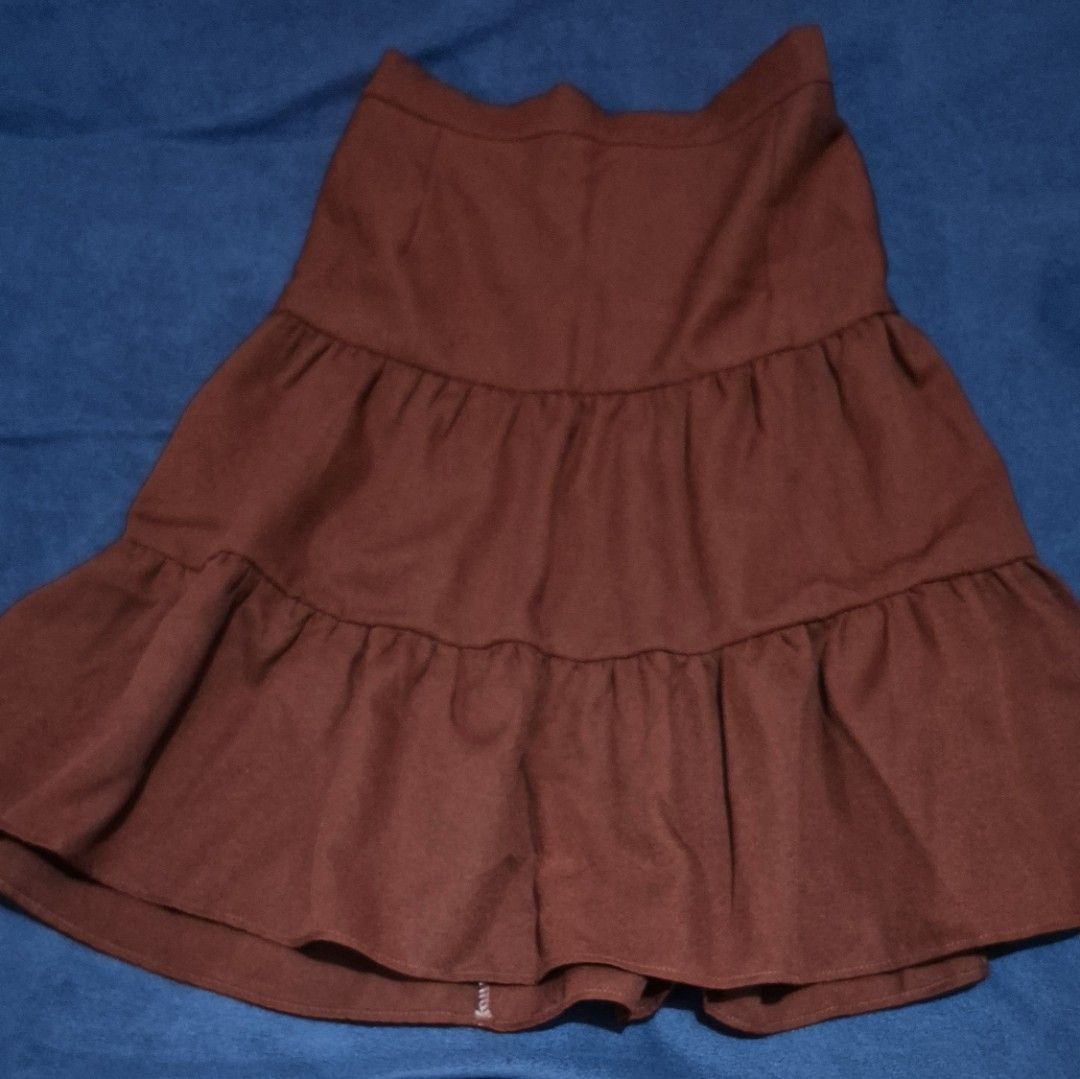 Coordinates Rust Brown Ruffle Crop Top And Tiered Skirt (Category: Sets or Coordinates) located in Imus. Submitted by shopestepanimey (Listing ID 1468553254, Image 2). Description: - Color: Rust brown Size Small - Material: Soft suede-like fabric - Set includes: Crop top (wide ruffle straps, elastic hem) and high-waisted skirt (3-tier ruffled design) - Condition: Worn only a few times, no flaws found - Perfect for: Sunny days and casual outings.