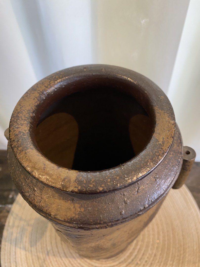 Rustic brown ceramic pottery vase with side handles (Category: Vases & Decorative Bowls) located in San Pedro. Submitted by jingay81 (Listing ID 1468708706, Image 3). Description: - Handmade ceramic pottery vase - Deep dark brown glaze with textured earth-tone patches - Features two vertical side handles and a flat stable base - Stands approximately 13 inches tall - Heavyweight stoneware with an organic, wabi-sabi aesthetic - Clean interior, idea